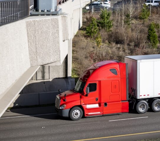 tractor trailer driving on a highway