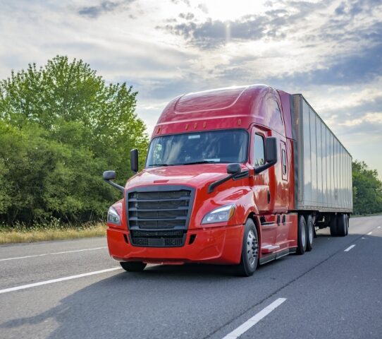 tractor trailer driving on highway