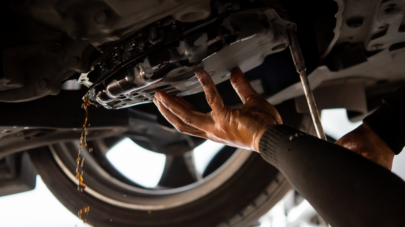 person working on the engine with brava transmission fluids